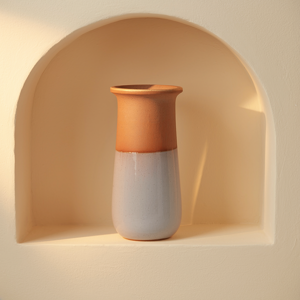 Half-Dip Glaze Clay Vase in a cream plaster niche with warm natural side light