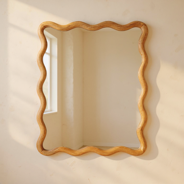 Wavy Mango Wood Wall Mirror against cream limewash with a softly reflected room