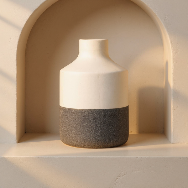 Dual-Texture Matte Ceramic Vase in a cream plaster niche with warm natural side light