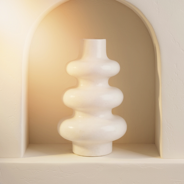 Gloss White Stacked Bubble Gypsum Vase in a cream plaster niche with warm natural side light