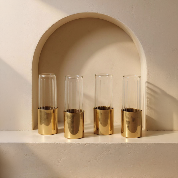 Fluted Glass Bud Vases, Set of 4 in a cream plaster niche with warm natural side light
