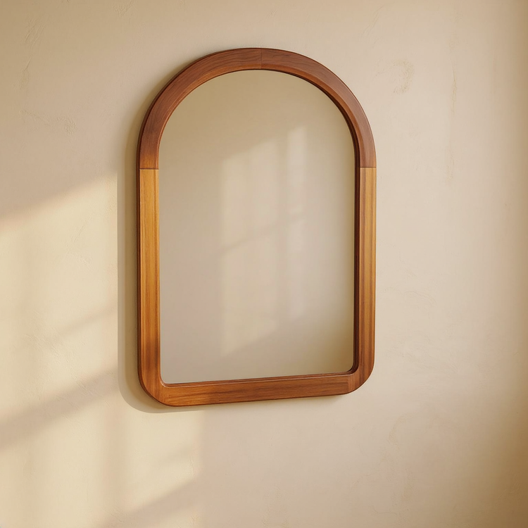 Arched Walnut Wood Frame Wall Mirror against cream limewash with a softly reflected room