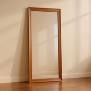 Walnut-Finish Wood Frame Full-Length Mirror against cream limewash with a softly reflected room
