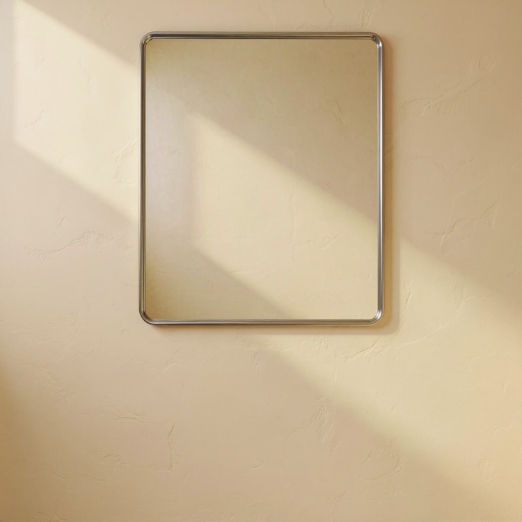 Brushed Nickel Rounded Rectangle Bathroom Mirror against a cream limewash wall with warm natural side light