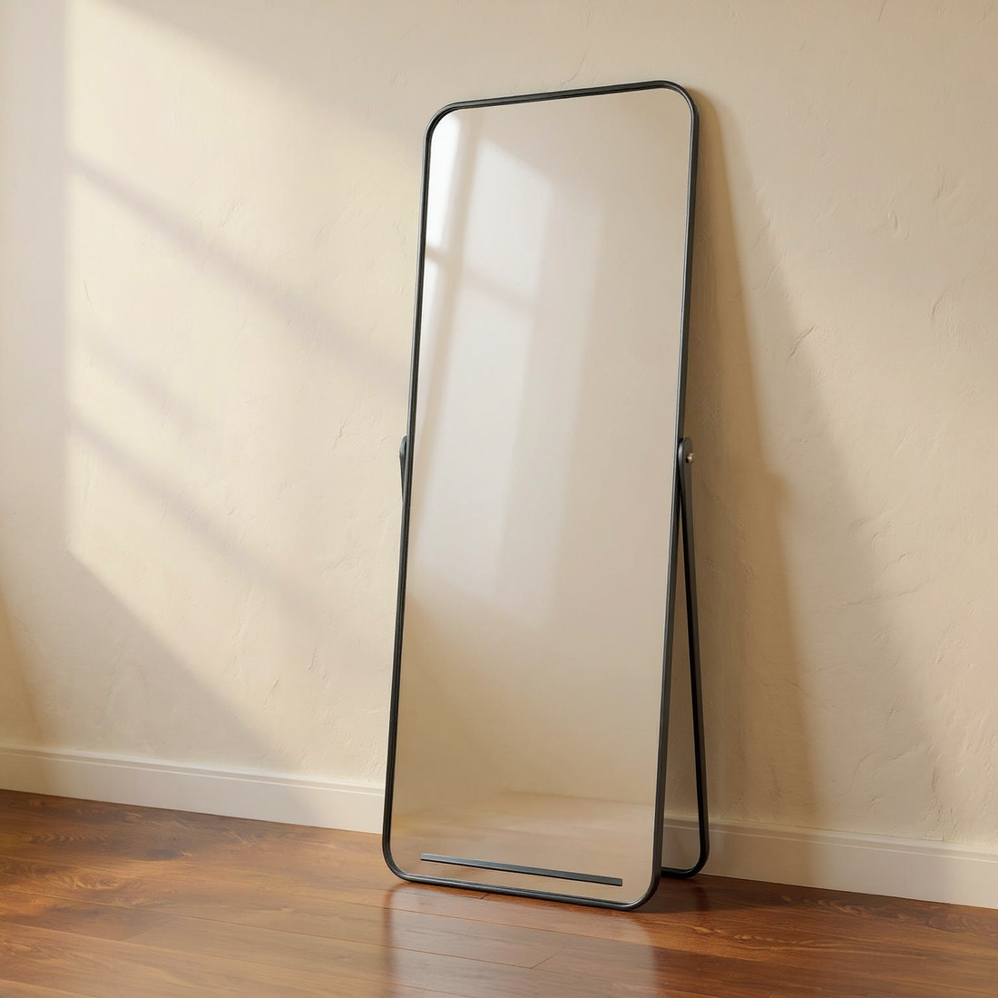 Full-Length Black Aluminum Floor Mirror against cream limewash with a softly reflected room.