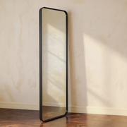 Matte Black Full-Length Floor Mirror against a cream limewash wall with warm natural side light