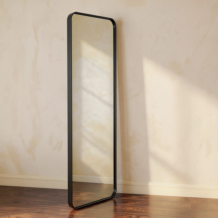 Matte Black Full-Length Floor Mirror against a cream limewash wall with warm natural side light