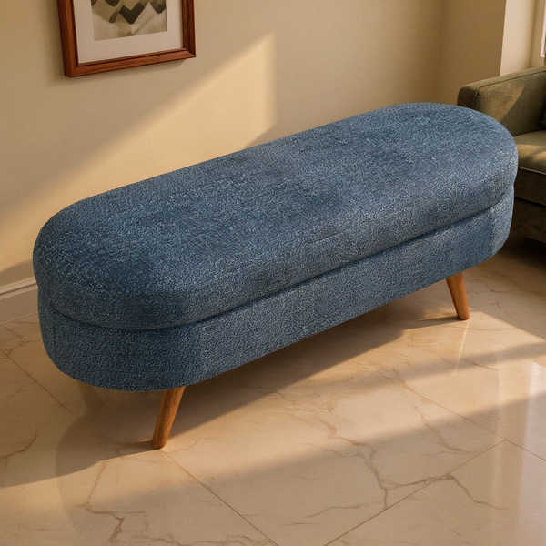 Oval Upholstered Storage Bench Wood Legs on a travertine floor in a sunlit room with cream limewash walls