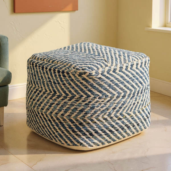 Chevron Woven Denim Square Pouf on a travertine floor in a sunlit room with cream limewash walls