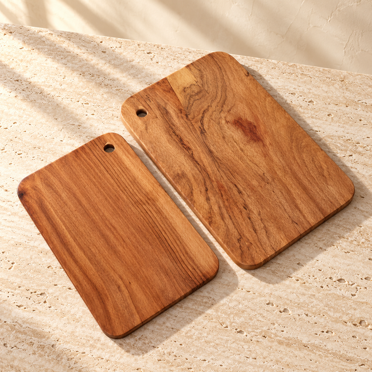 Acacia Wood Cutting Board Set on a sunlit pale travertine counter
