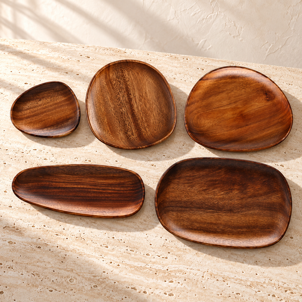 Dark Wood-Grain Oval Serving Board Set on a sunlit pale travertine counter