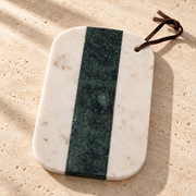 Green & White Marble Cheese Board on a sunlit pale travertine counter