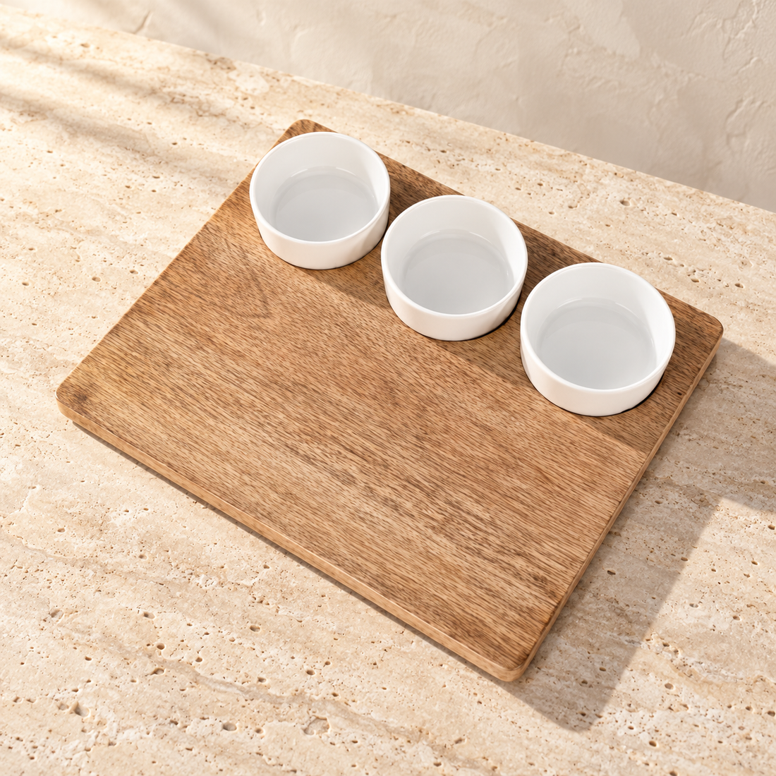 Mango Wood Cheese Board with Ceramic Bowls on a sunlit pale travertine counter