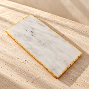 Marble Gold-Edge Serving Board on a sunlit pale travertine counter
