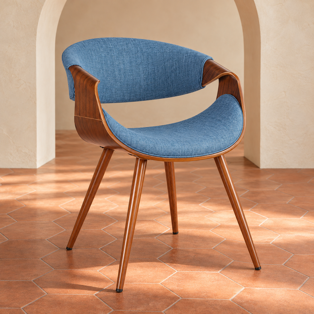 Dusk Blue Mid-Century Upholstered Dining Chair in a cream plaster room with terracotta hexagon flooring