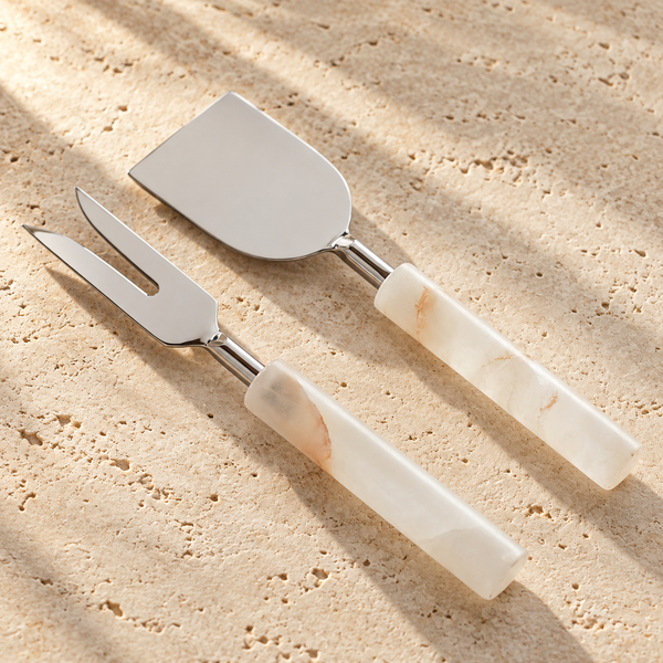 Alabaster Handle Cheese Tool Set on a sunlit pale travertine counter
