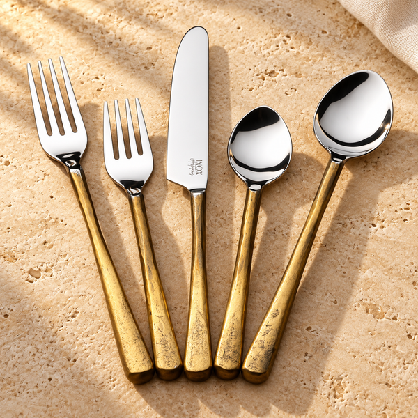 Beveled Handle Stainless Flatware Set on a sunlit pale travertine counter
