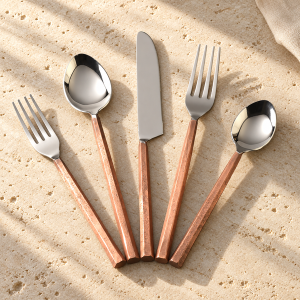 Faceted Handle Stainless Flatware Set on a sunlit pale travertine counter