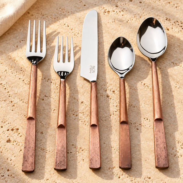 Faceted Handle Stainless Steel Flatware Set on a sunlit pale travertine counter