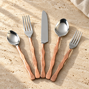 Hammered Handle Flatware Place Setting on a sunlit pale travertine counter