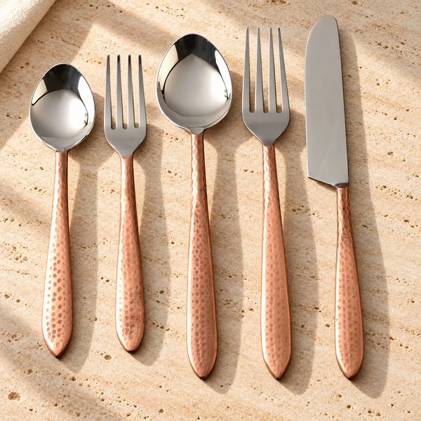 Hammered Stainless Steel Flatware Set on a sunlit pale travertine counter