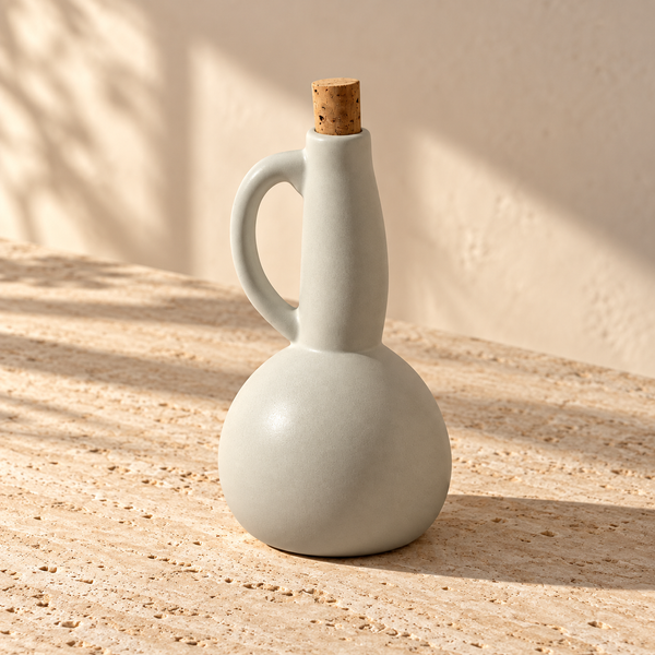 Matte Stoneware Olive Oil Dispenser on a sunlit pale travertine counter