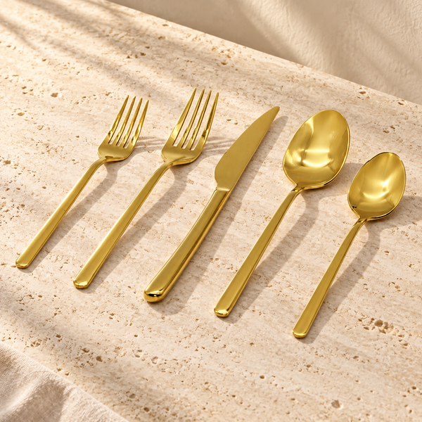Mirror-Polish Stainless Steel Flatware Set on a sunlit pale travertine counter
