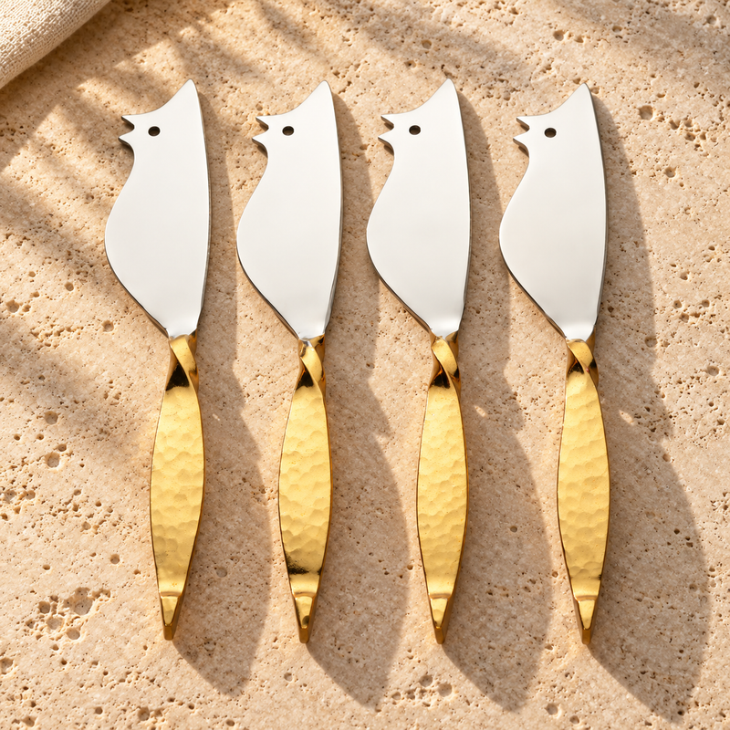 Mouse-Form Gold-Handle Cheese Knife Set on a sunlit pale travertine counter