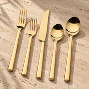 PVD-Coated Stainless Steel Flatware Set on a sunlit pale travertine counter
