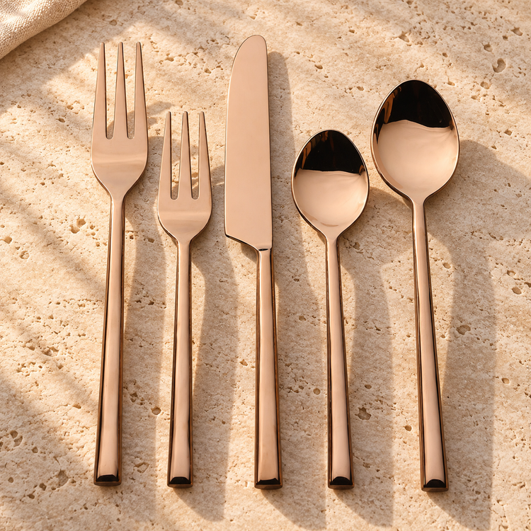 PVD-Coated Stainless Steel Flatware Set on a sunlit pale travertine counter