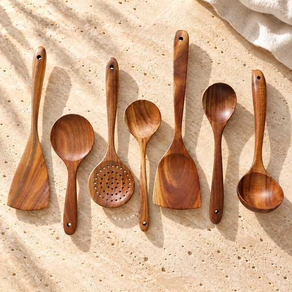 Teak-Grain Wood Cooking Utensil Set on a sunlit pale travertine counter