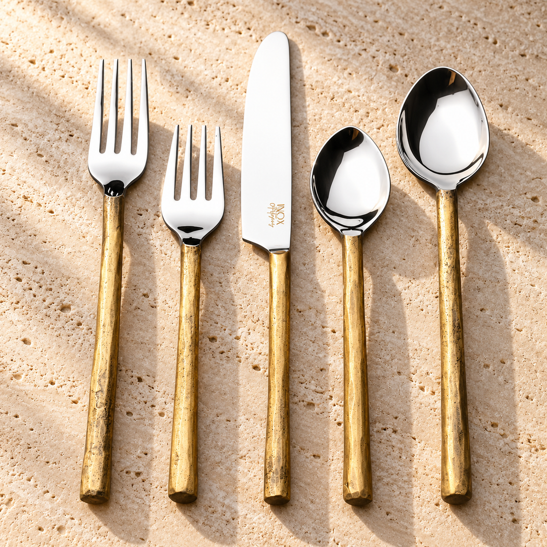 Textured Handle Stainless Steel Flatware Set on a sunlit pale travertine counter