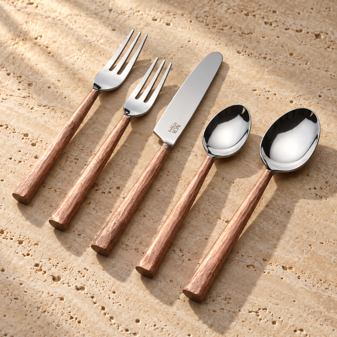 Textured Handle Stainless Flatware Set on a sunlit pale travertine counter