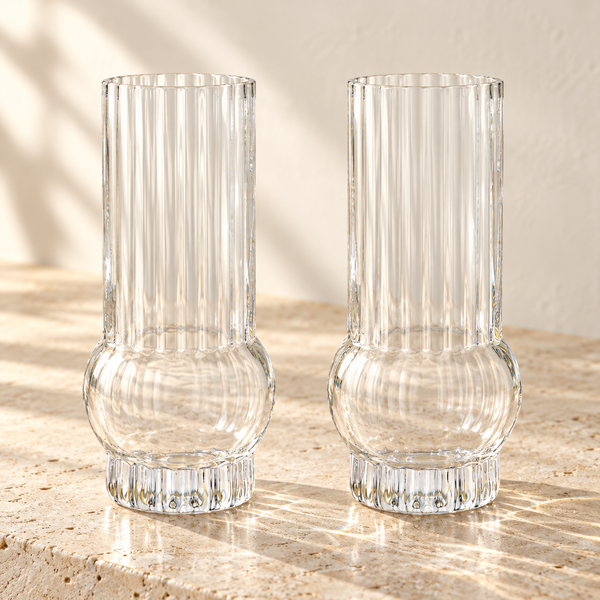 Art Deco Ribbed Crystal Highball Glass Set empty on honed travertine in warm side light