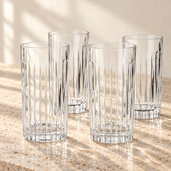 Ribbed Crystal Highball Glass Set empty on honed travertine in warm side light