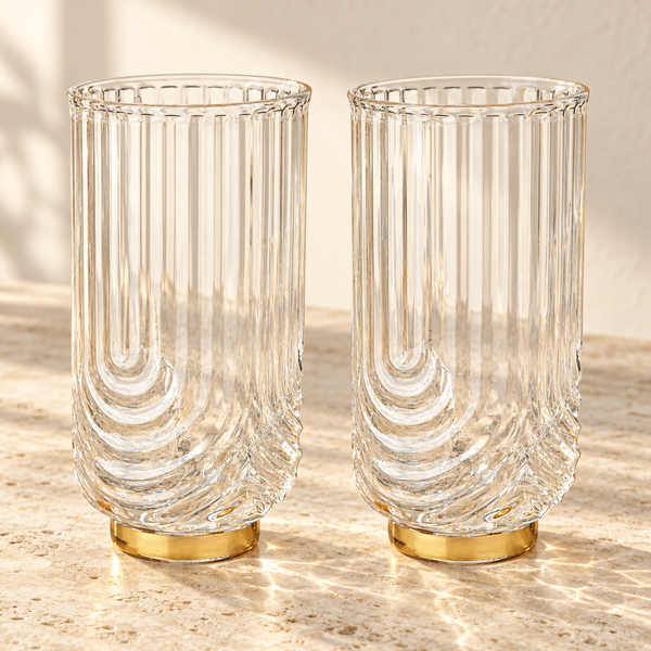 Art Deco Ribbed Crystal Highball Set empty on honed travertine in warm side light