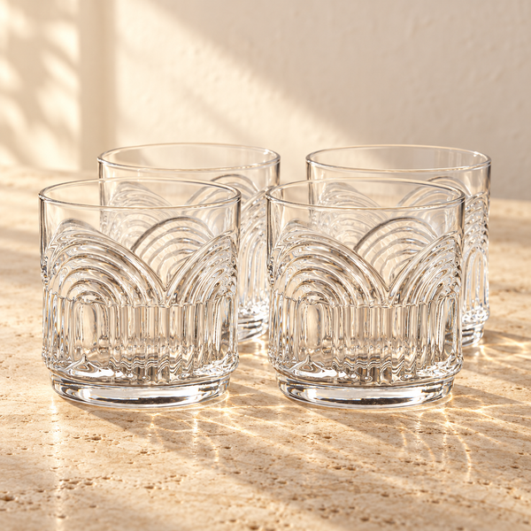 Art Deco Arch Crystal Tumbler Set empty on honed travertine in warm side light