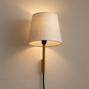 Tokyo Sconce illuminated against cream plaster