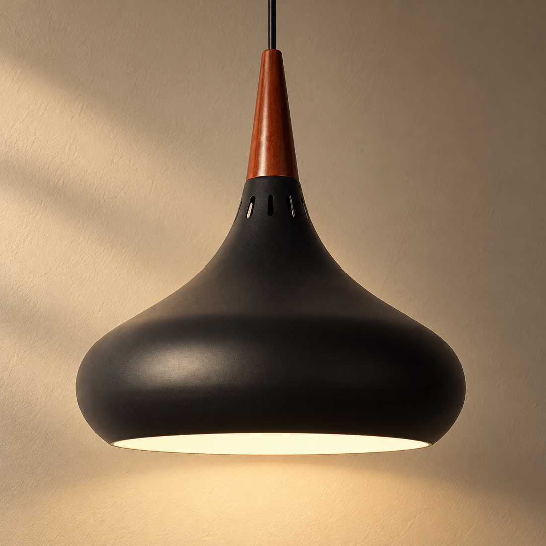 Teardrop LED Pendant Light illuminated against cream plaster