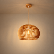 Slatted Wood Dome Pendant Light illuminated against cream plaster
