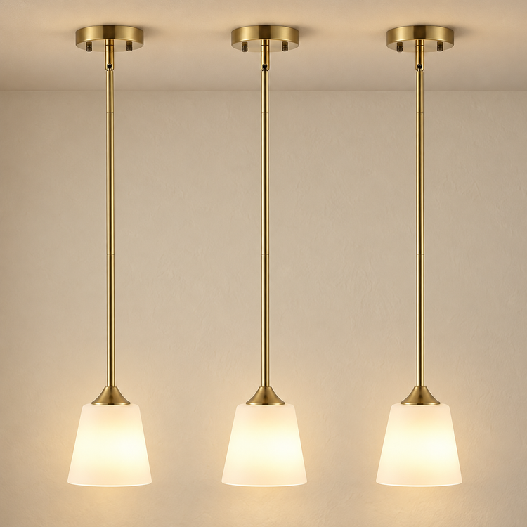 Brushed Brass 3-Light Pendant with White Glass Shades illuminated against cream plaster