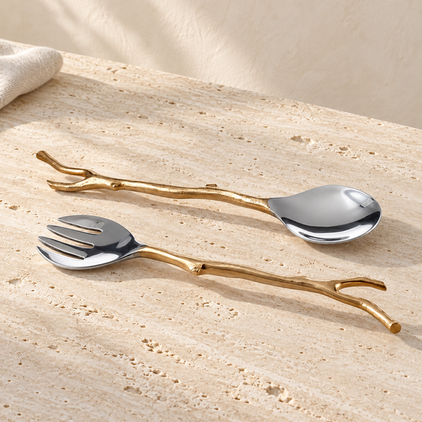 Branch-Handle Metal Salad Server Set on a sunlit pale travertine counter