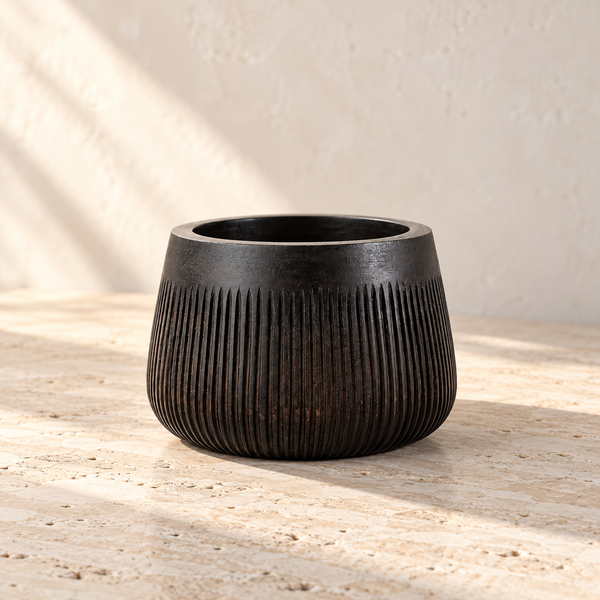 Chisel-Carved Wood Serving Bowl on a sunlit pale travertine counter