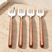 Copper-Handle Stainless Pastry Fork Set on a sunlit pale travertine counter