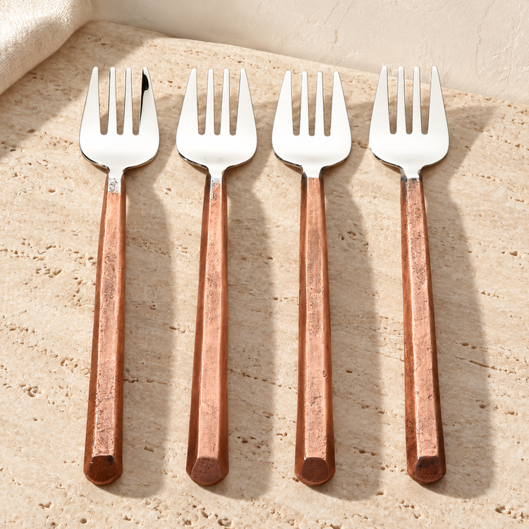 Copper-Handle Stainless Pastry Fork Set on a sunlit pale travertine counter
