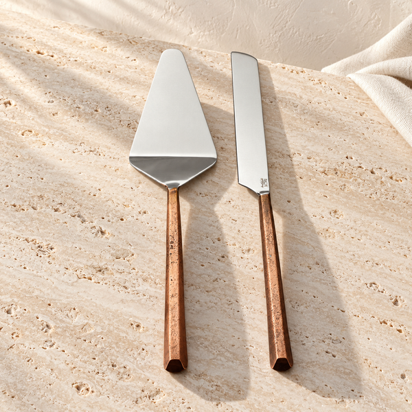 Copper-Tone Stainless Cake Server Set on a sunlit pale travertine counter