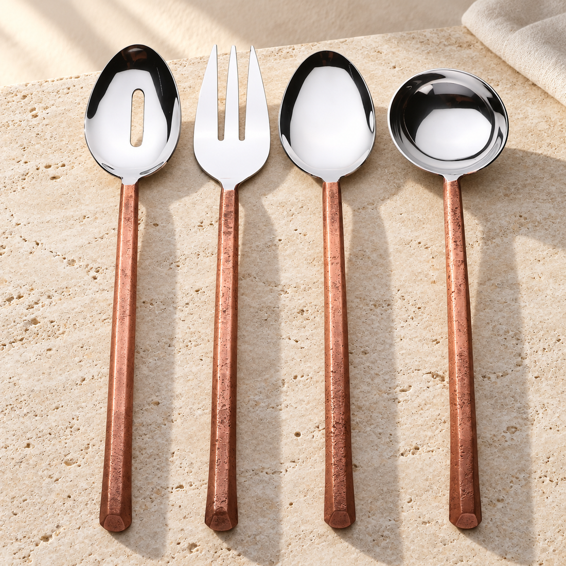 Copper-Finish Stainless Steel Serving Set on a sunlit pale travertine counter
