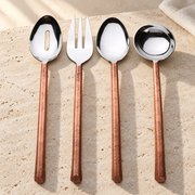 Copper-Finish Stainless Steel Serving Set on a sunlit pale travertine counter