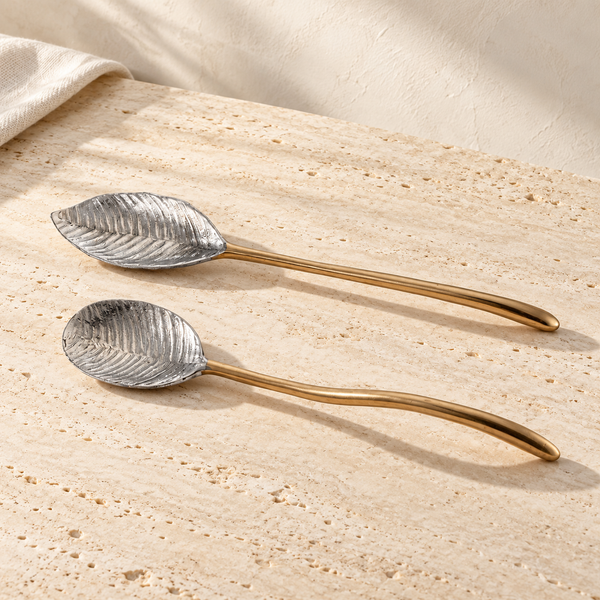 Feather-Motif Cast Metal Serving Set on a sunlit pale travertine counter