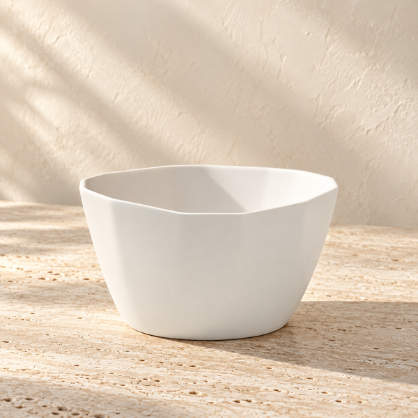 Handmade Porcelain Nesting Bowl on a sunlit pale travertine counter